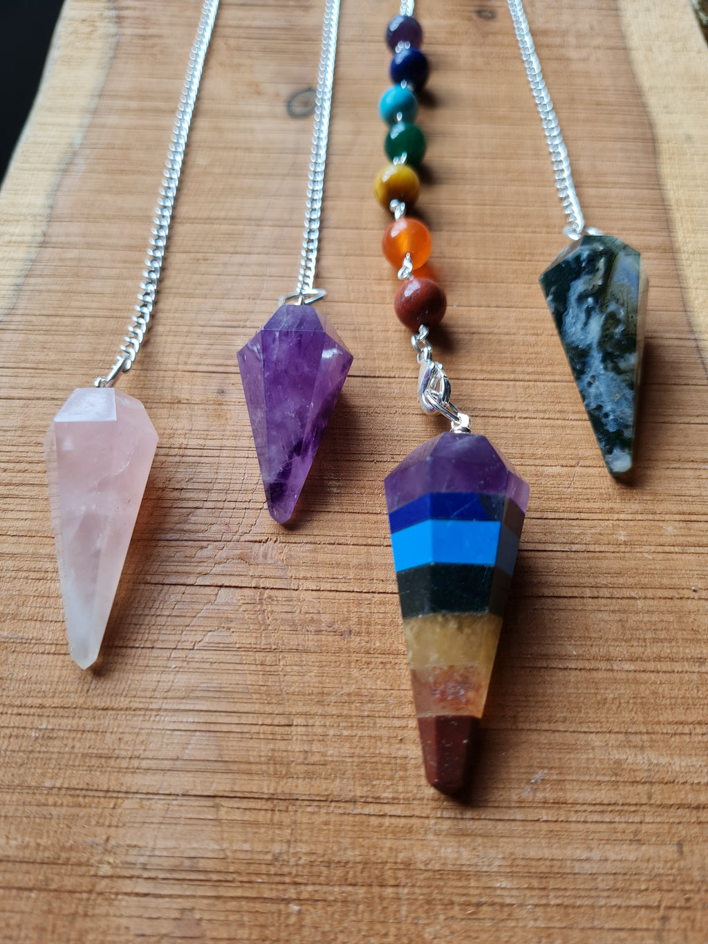 Crystal pendulums on a wooden board