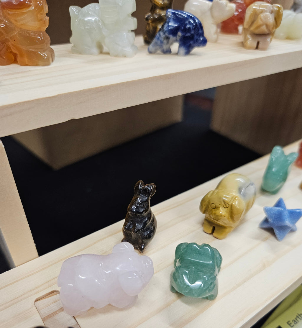 Colorful stone animal figurines on a wooden shelf