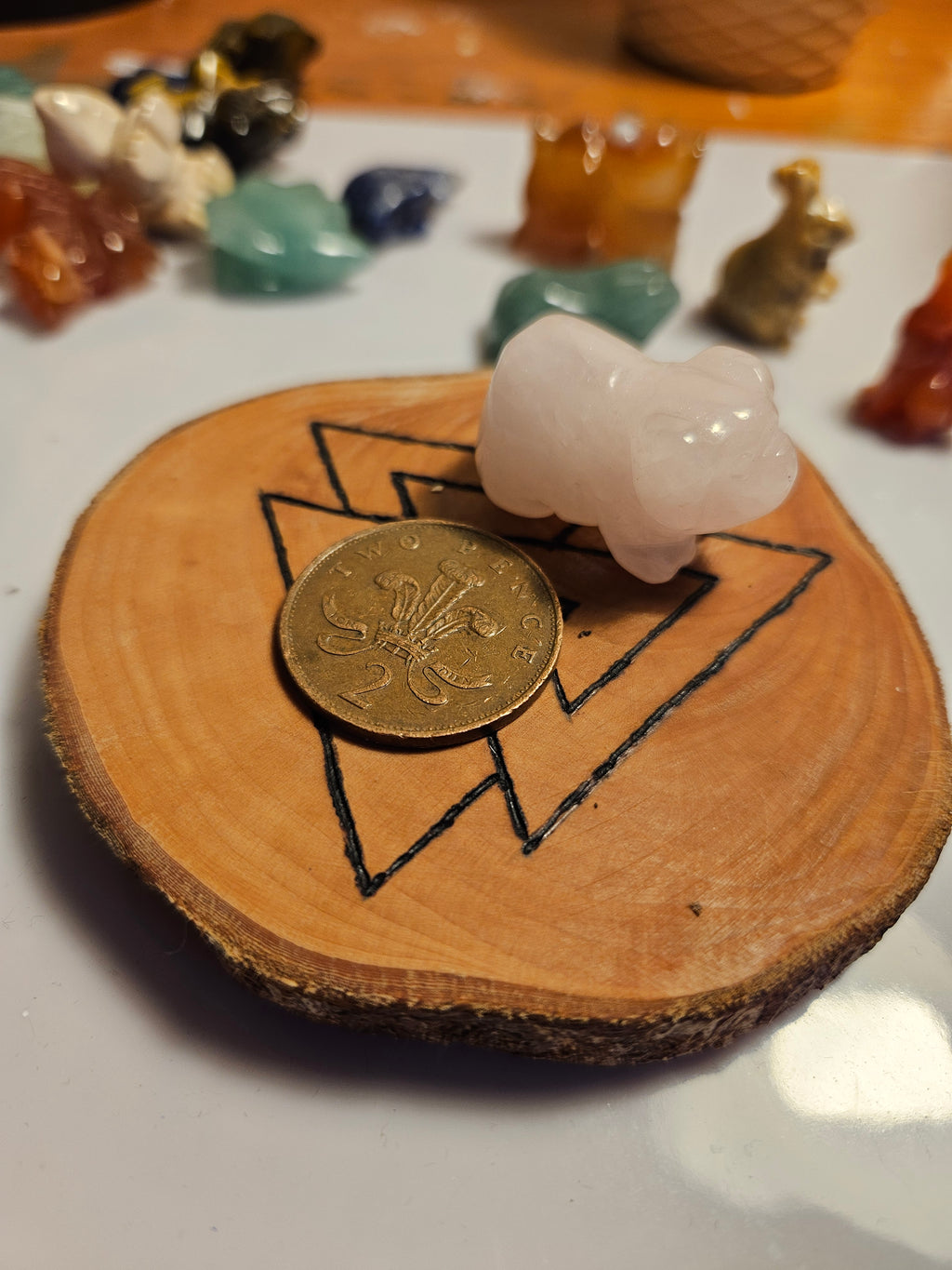 Rose Quartz pig next to a coin to show size
