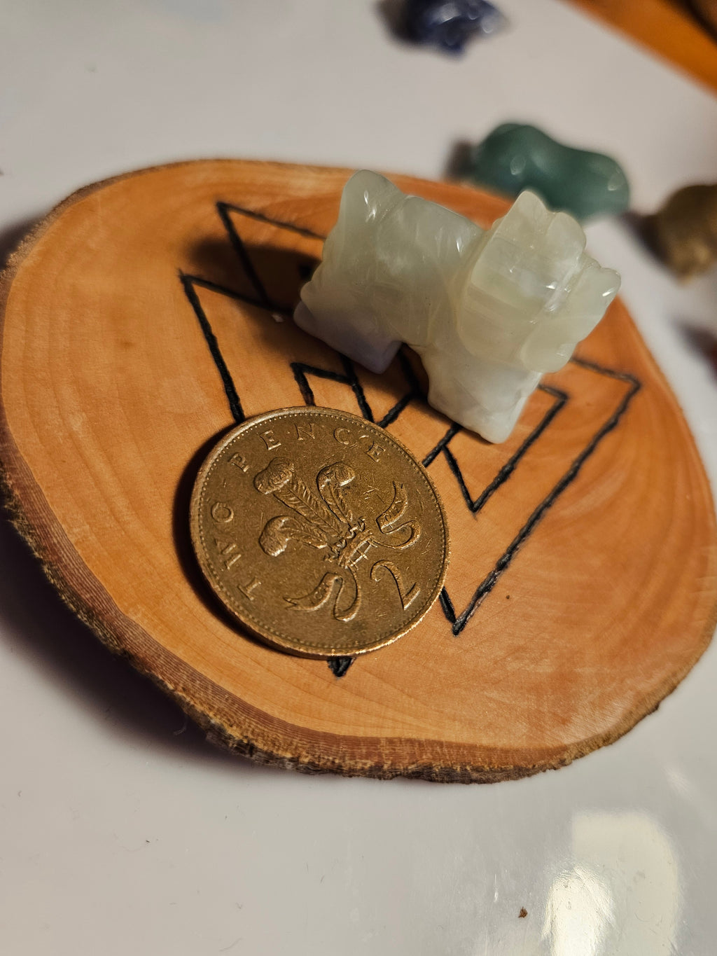 Jade dragon next to a two pence coin to show size