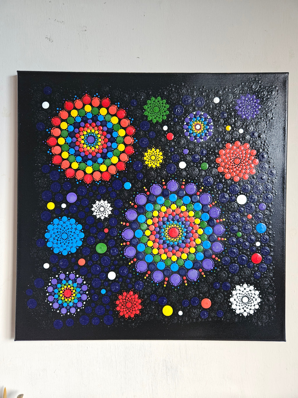 Colorful abstract art piece with circular patterns on a dark background
