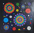 Colorful dot mandala pattern on a black background