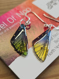 Fairy wing earrings on a business card