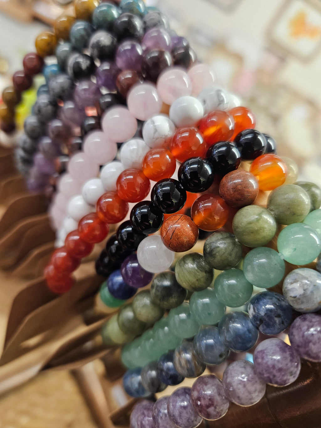 Close up of multiple gemstone power bracelets