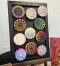 Hand painted mandalas with multicoloured backgrounds on ceramic magnets 