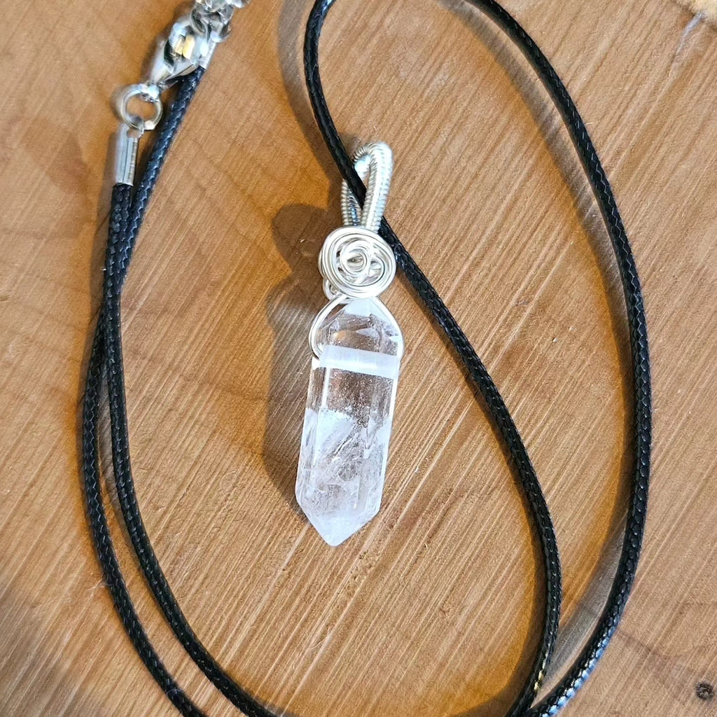 Crystal pendant necklace on a wooden surface
