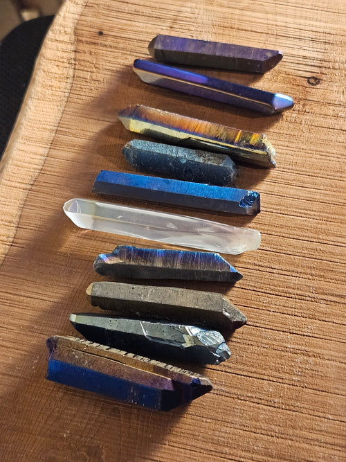 Various Aura Quartz points on a wooden board