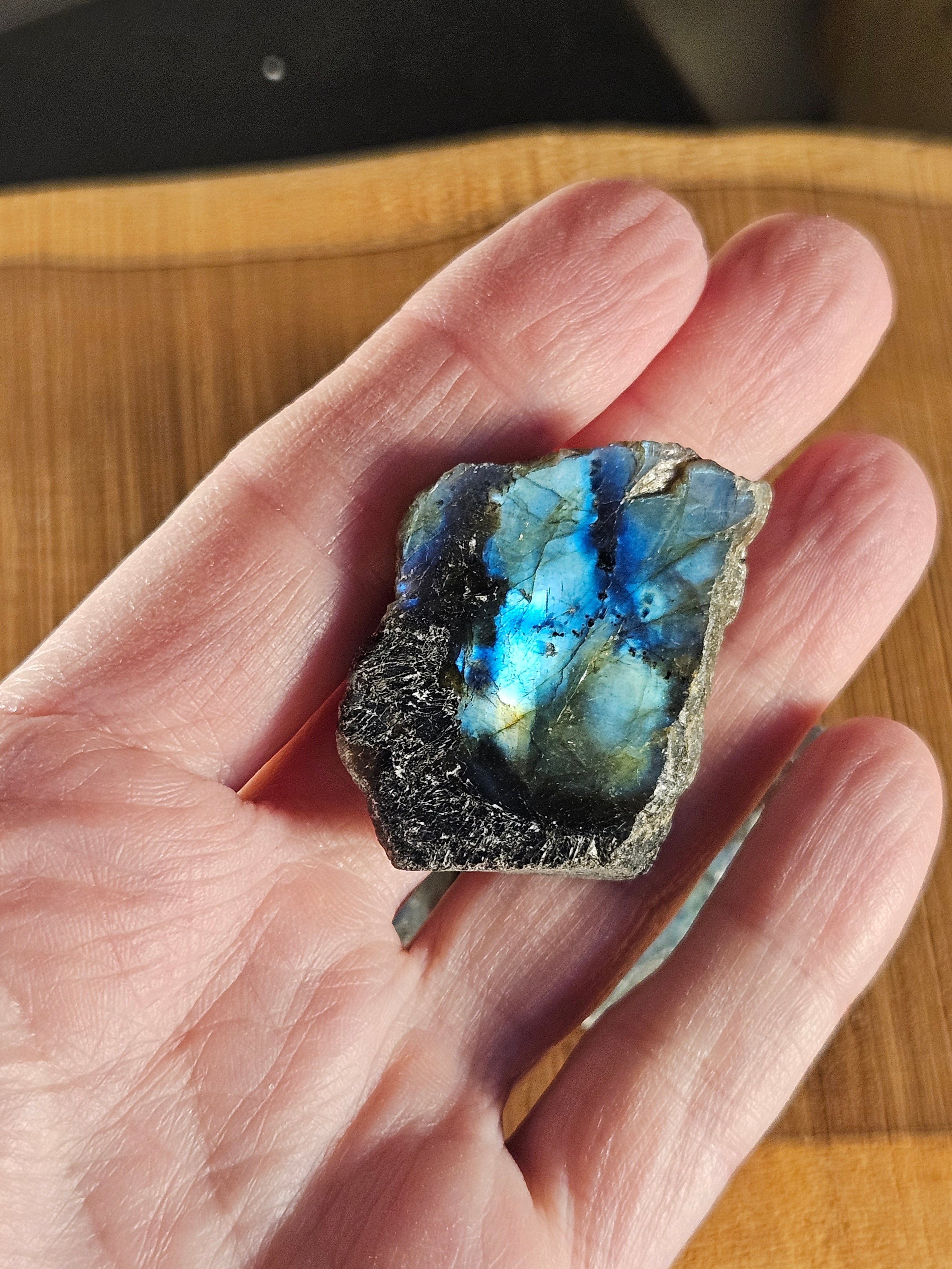 Hand holding labradorite to show size