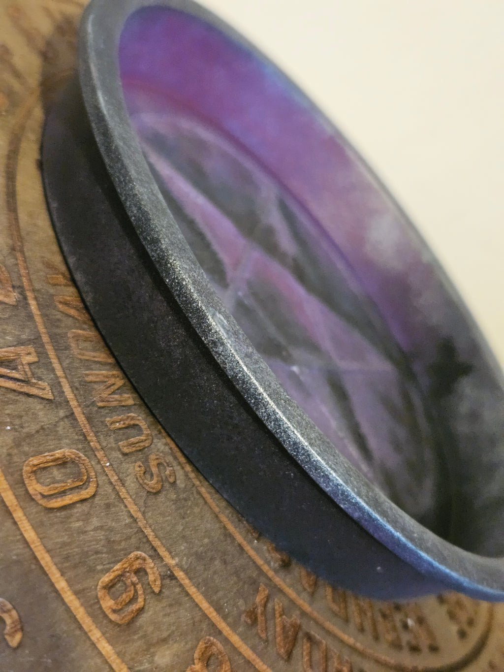 Side view of black and purple bowl