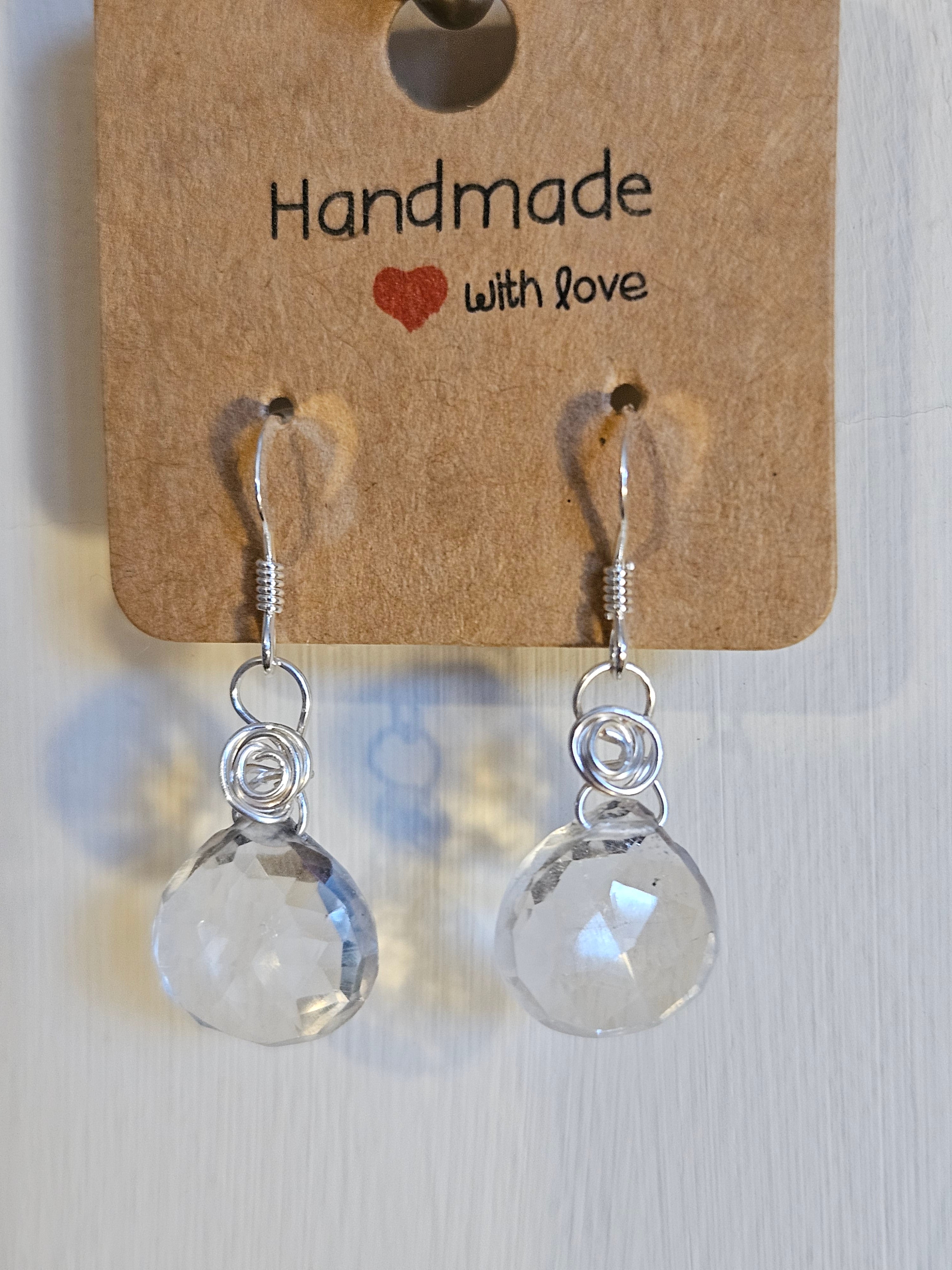 Pair of clear teardrop earrings on a 'Handmade with Love' card.