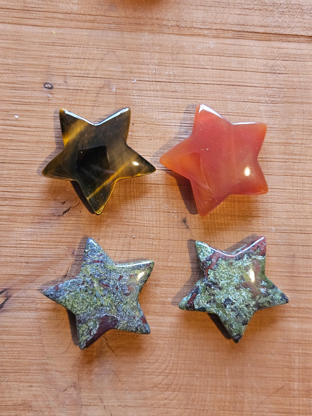 Four crystal stars on a wooden background