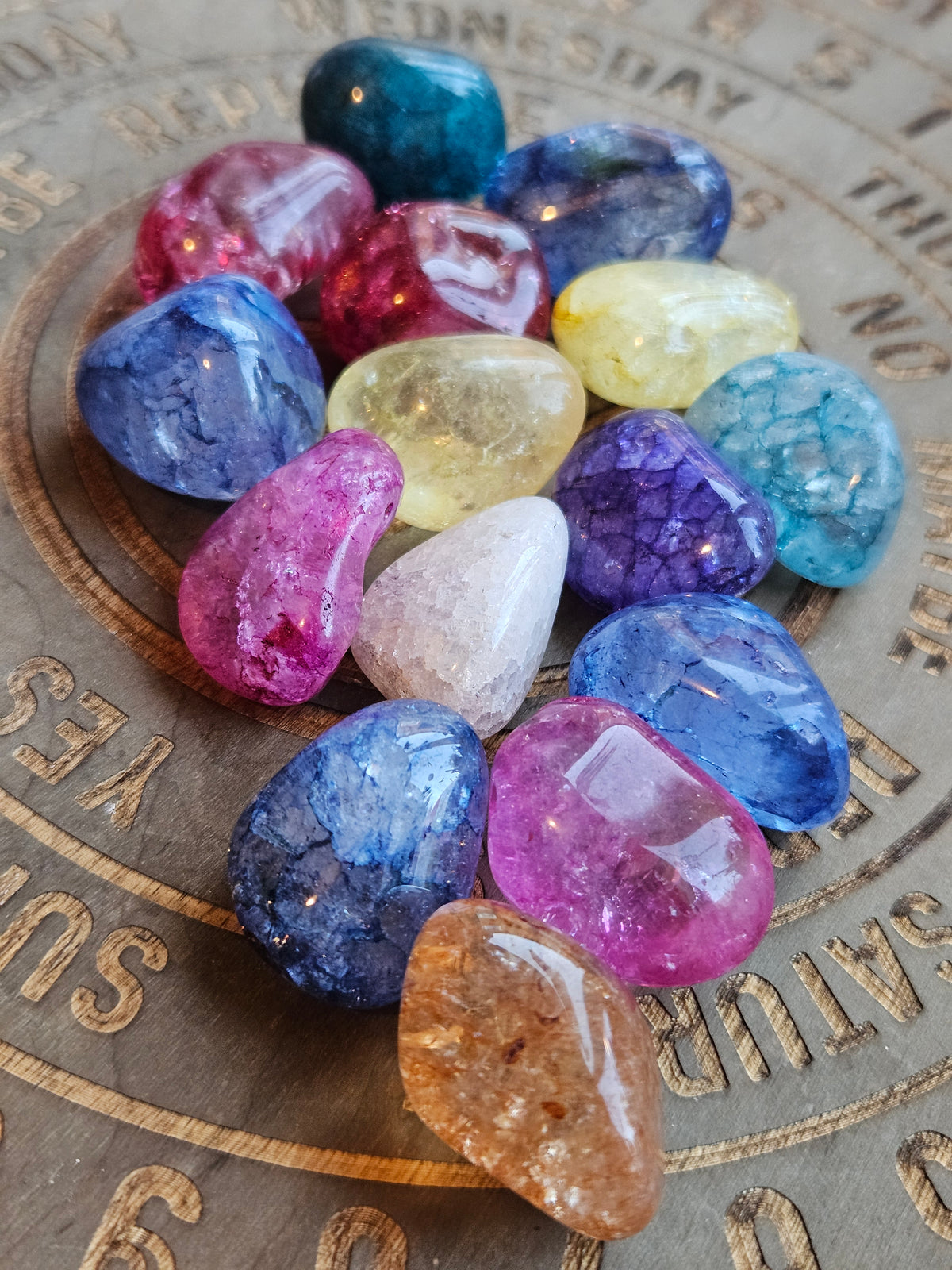 Rainbow coloured Crackle Quartz on a wooden board