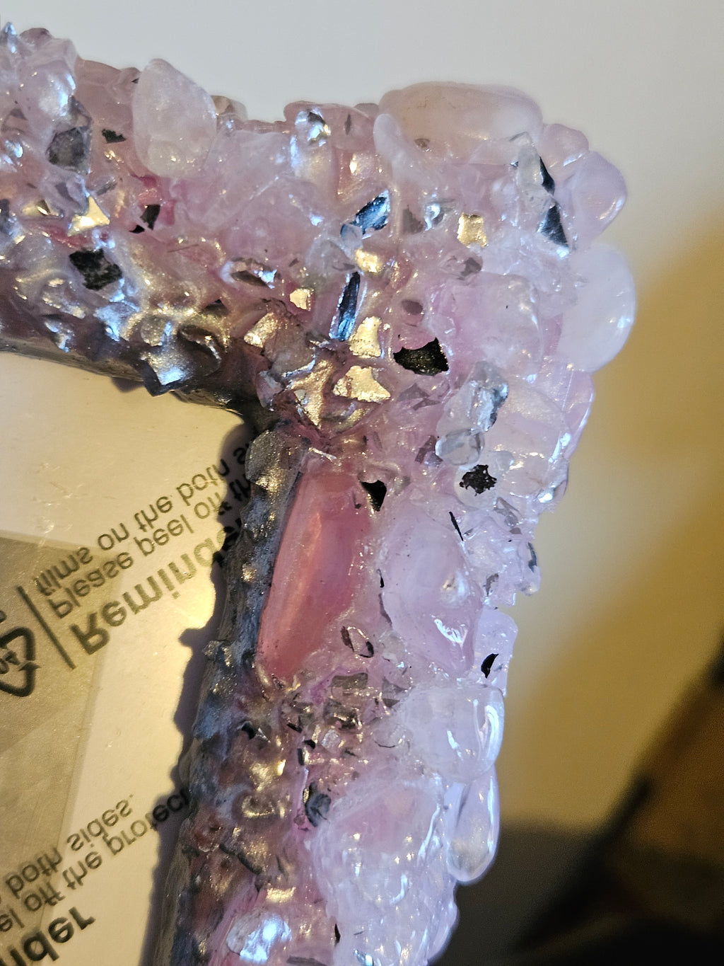 Close-up of a pink crystal photo frame on a blurred background