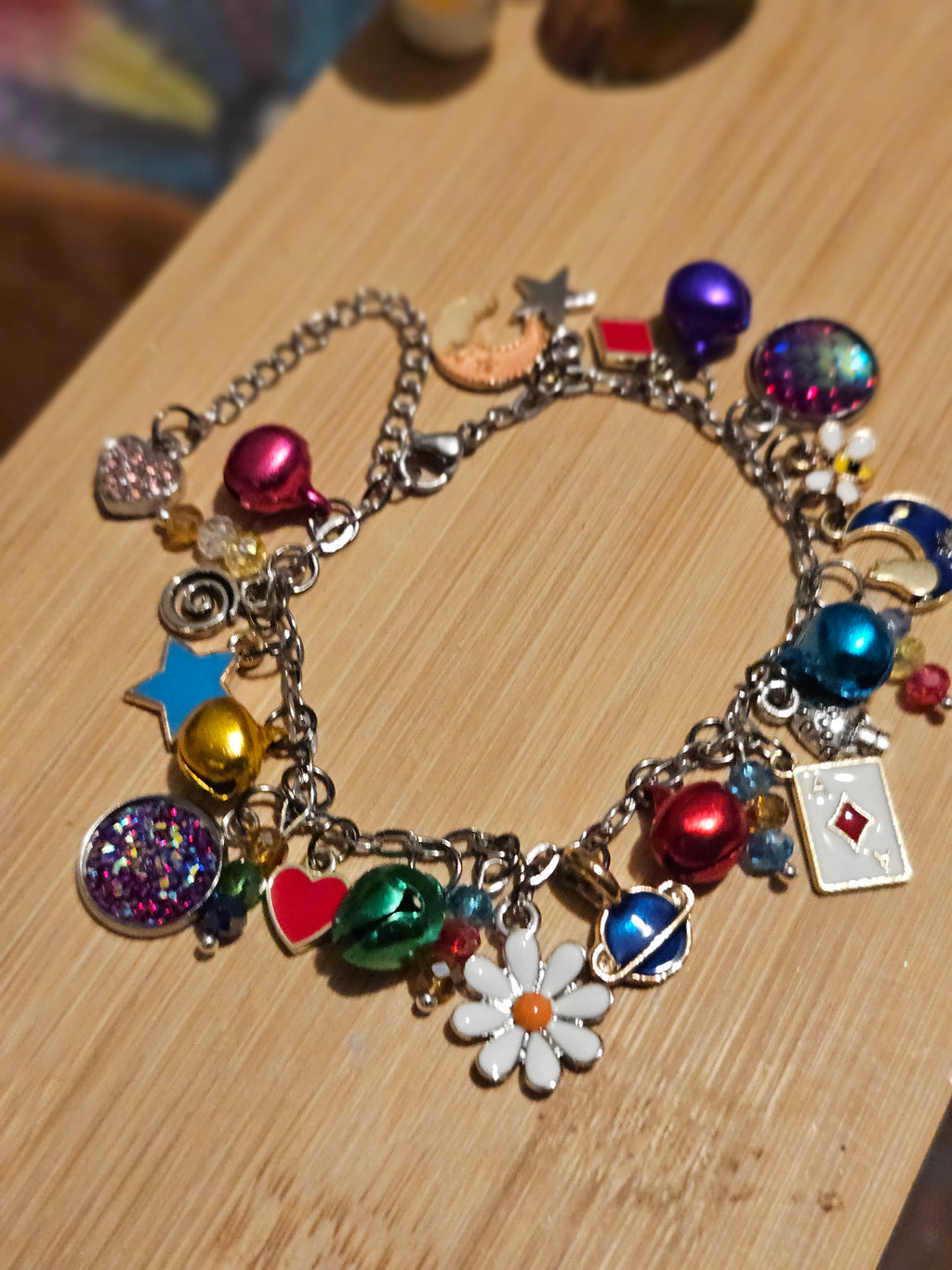 Multicolored charm bracelet on a wooden surface