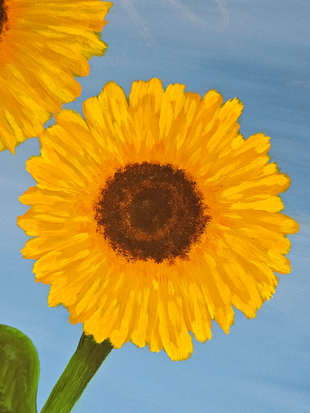 Close-up of a yellow sunflower against a blue sky