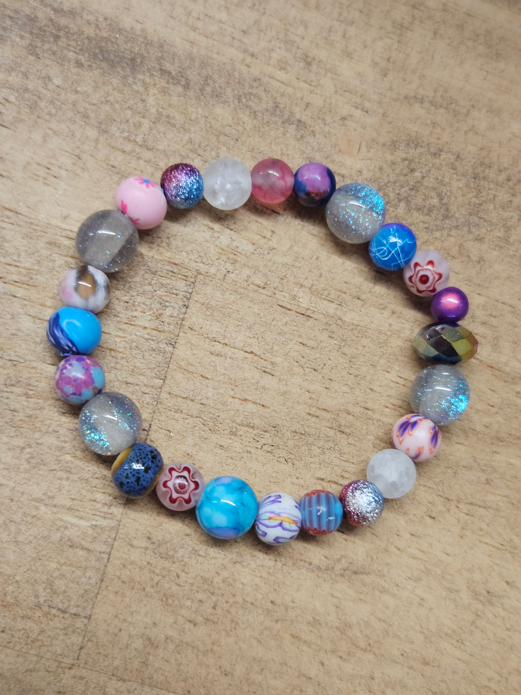 Multicolored beaded bracelet on a wooden surface