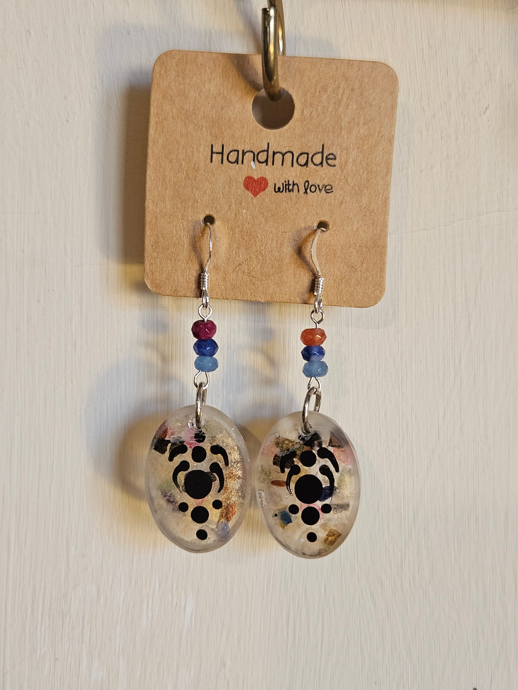 Pair of earrings with design on a 'Handmade with Love' card.