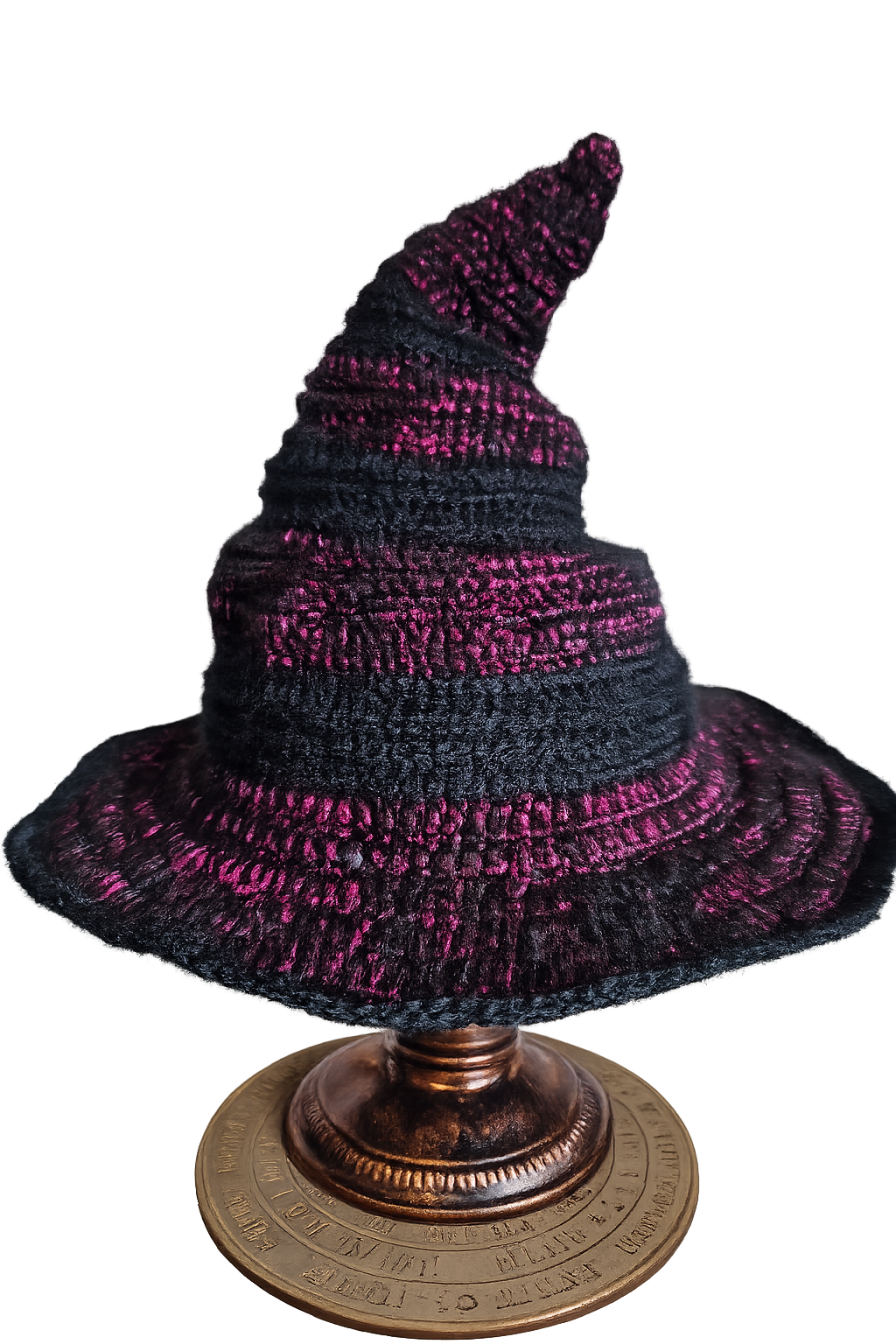 Crocheted witch hat with purple and black pattern on a decorative stand.