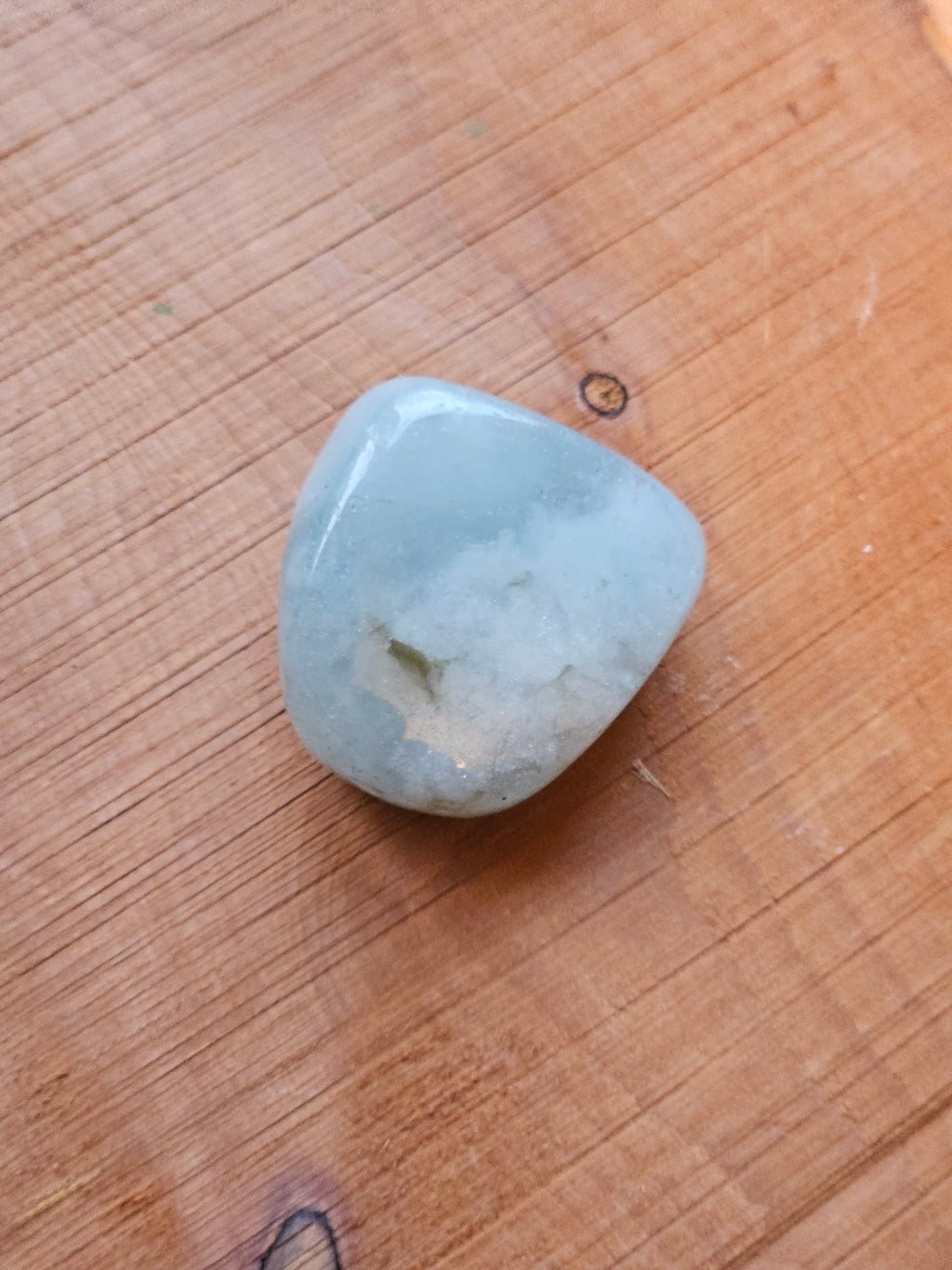 Aquamarine stone on a wooden board
