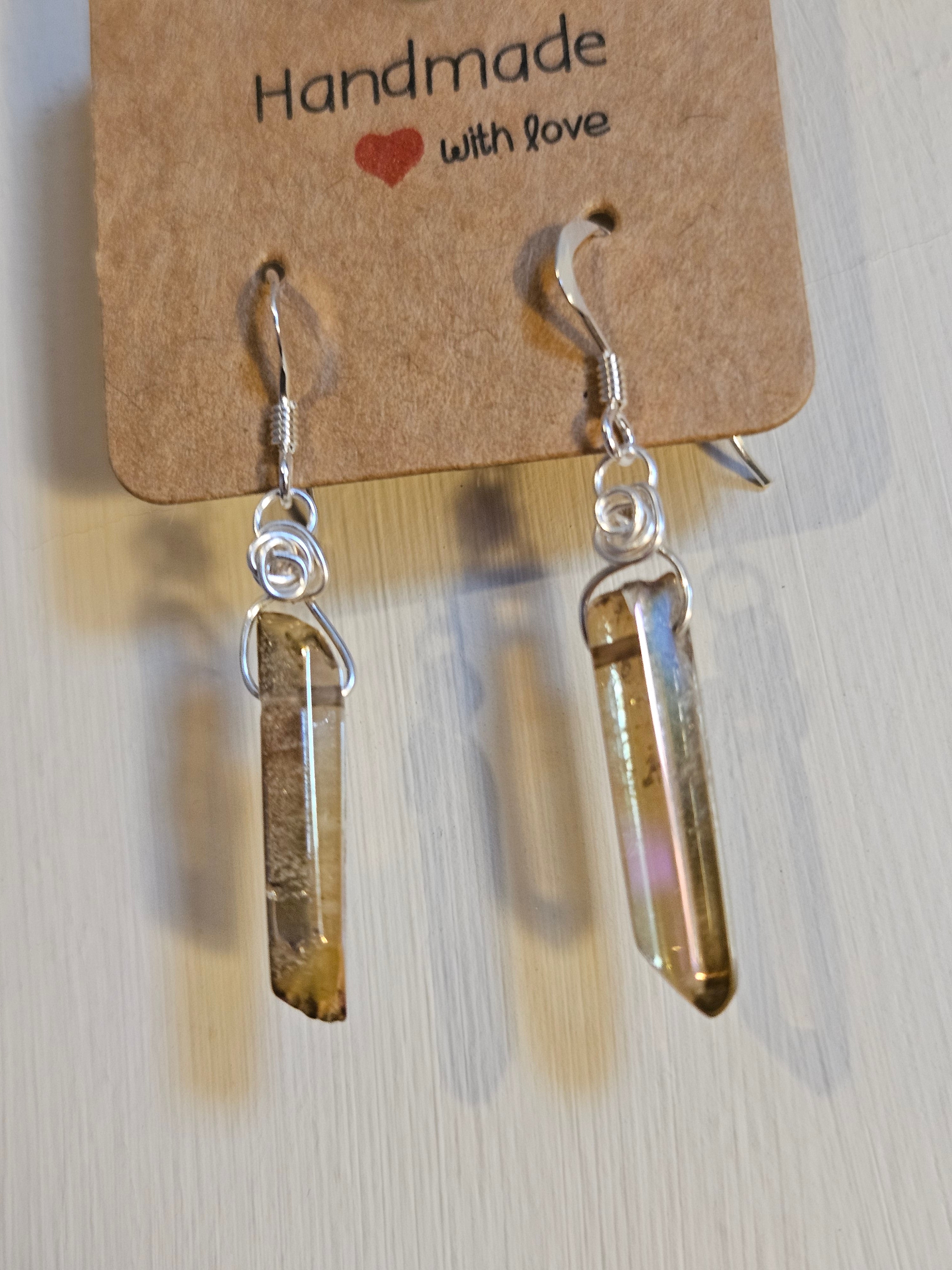 Crystal earrings on a 'Handmade with Love' card against a light background