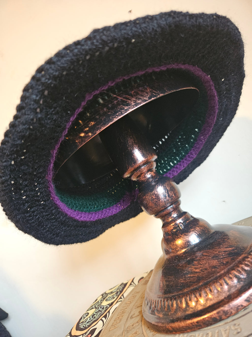 Bottom view of hat on a metal stand