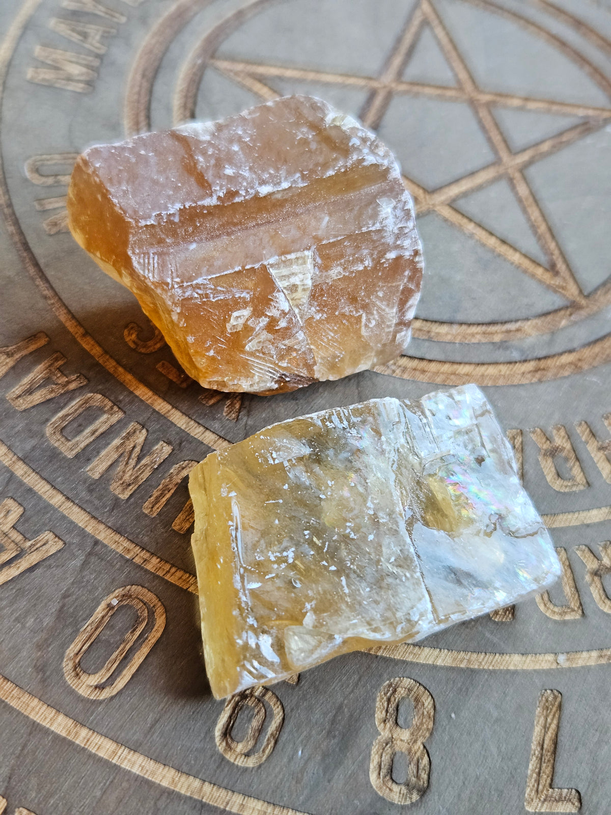 Citrine Calcite chunks on a wooden board with pentagram