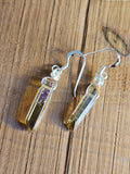 Crystal earrings on a wooden surface
