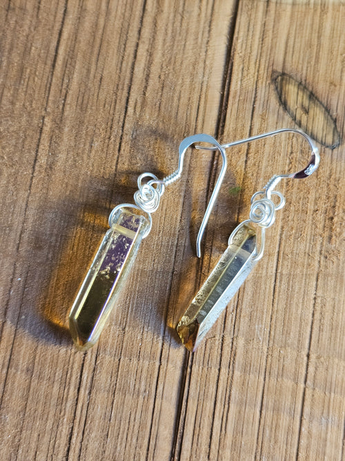 Crystal earrings on a wooden surface