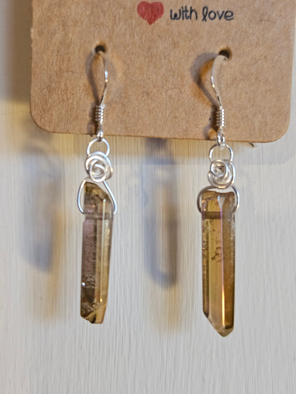 Crystal earrings on a cardboard tag with 'with love' text.