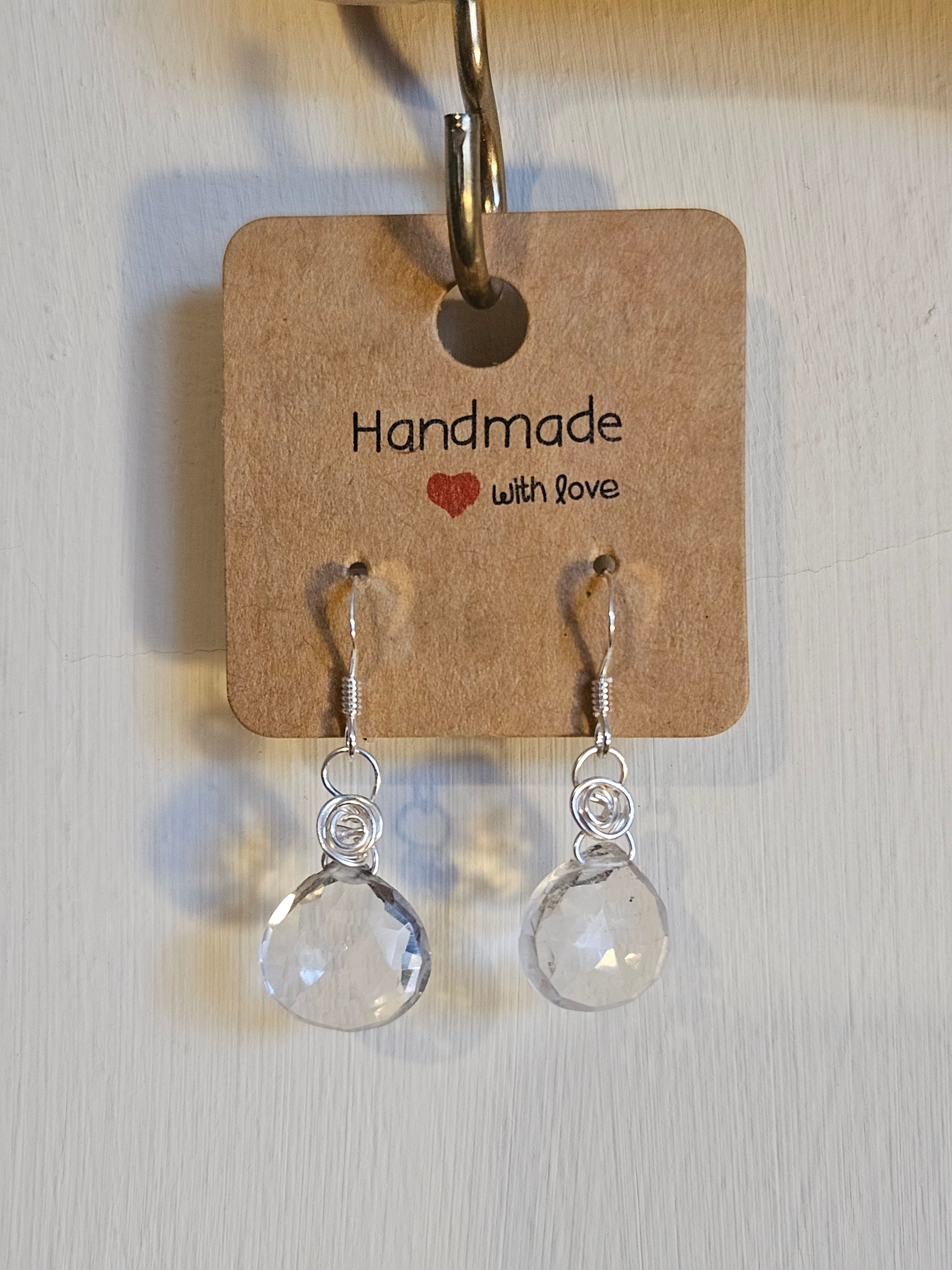 Pair of clear teardrop earrings on a 'Handmade with Love' card.