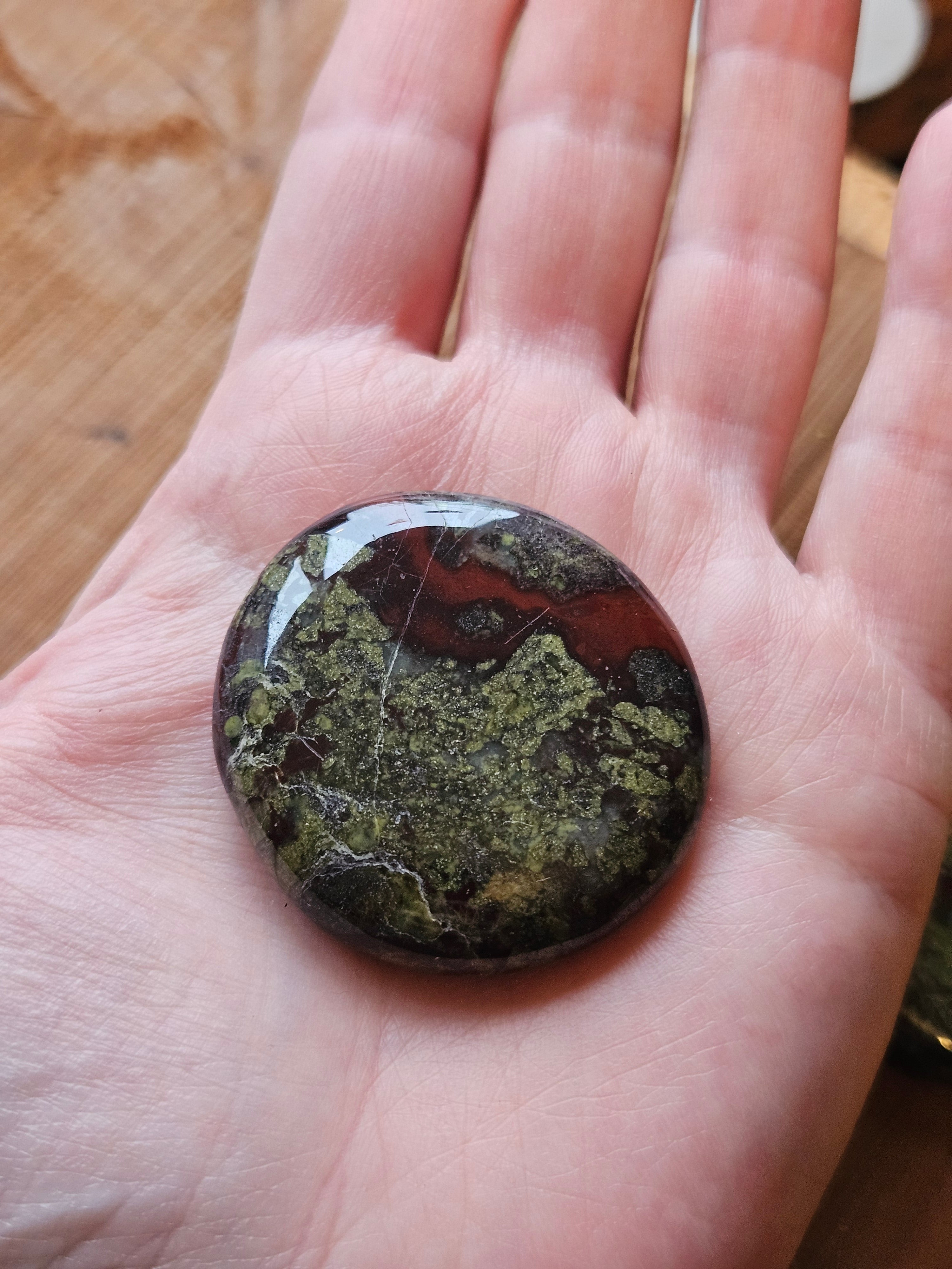 Hand holding Dragon Stone smoothstone to show size