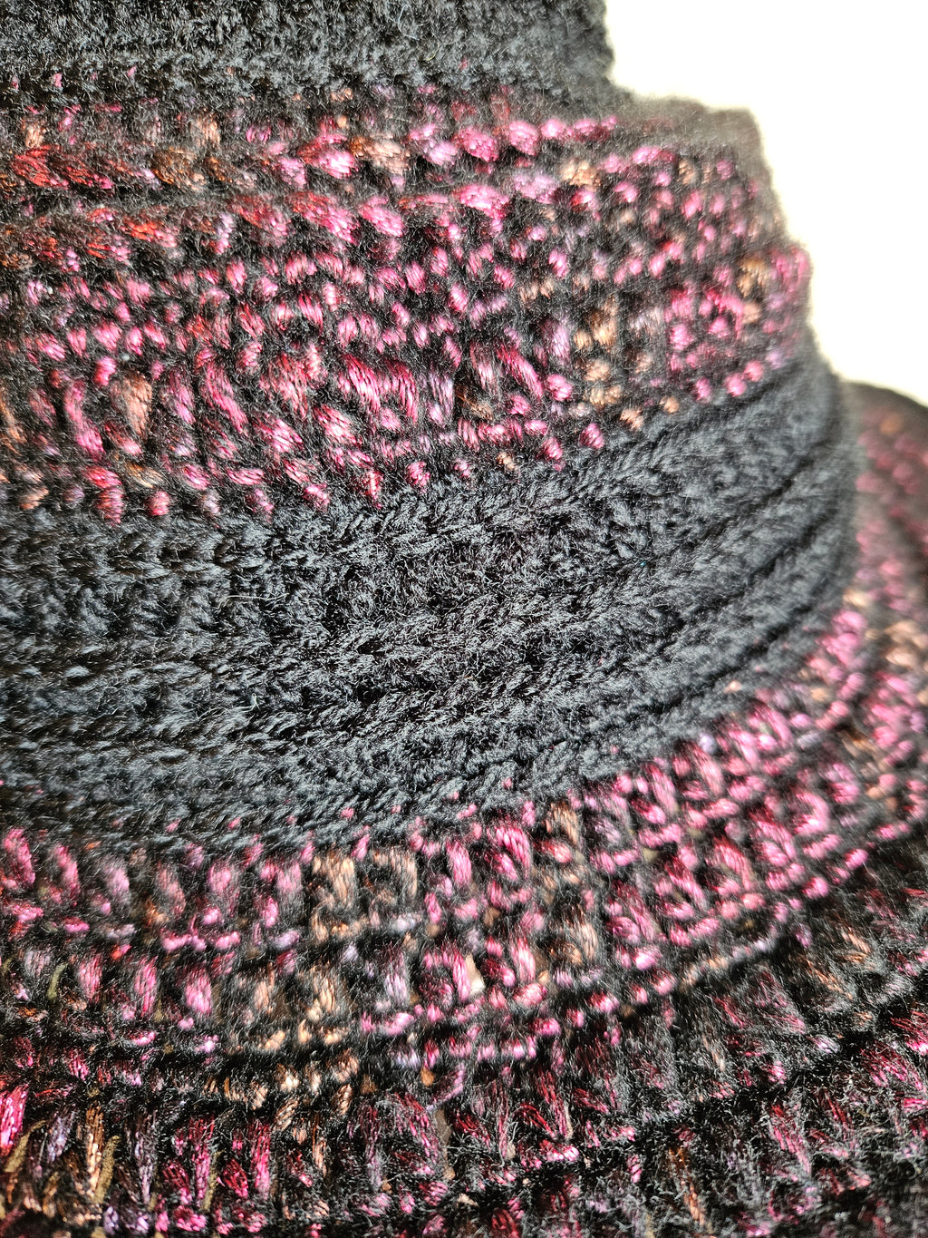 Close-up of a crochet hat with red and black patterns