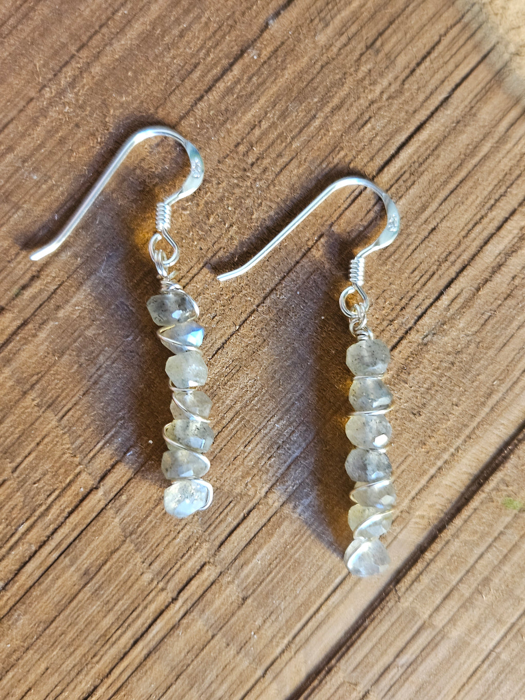 Pair of beaded earrings on a wooden surface