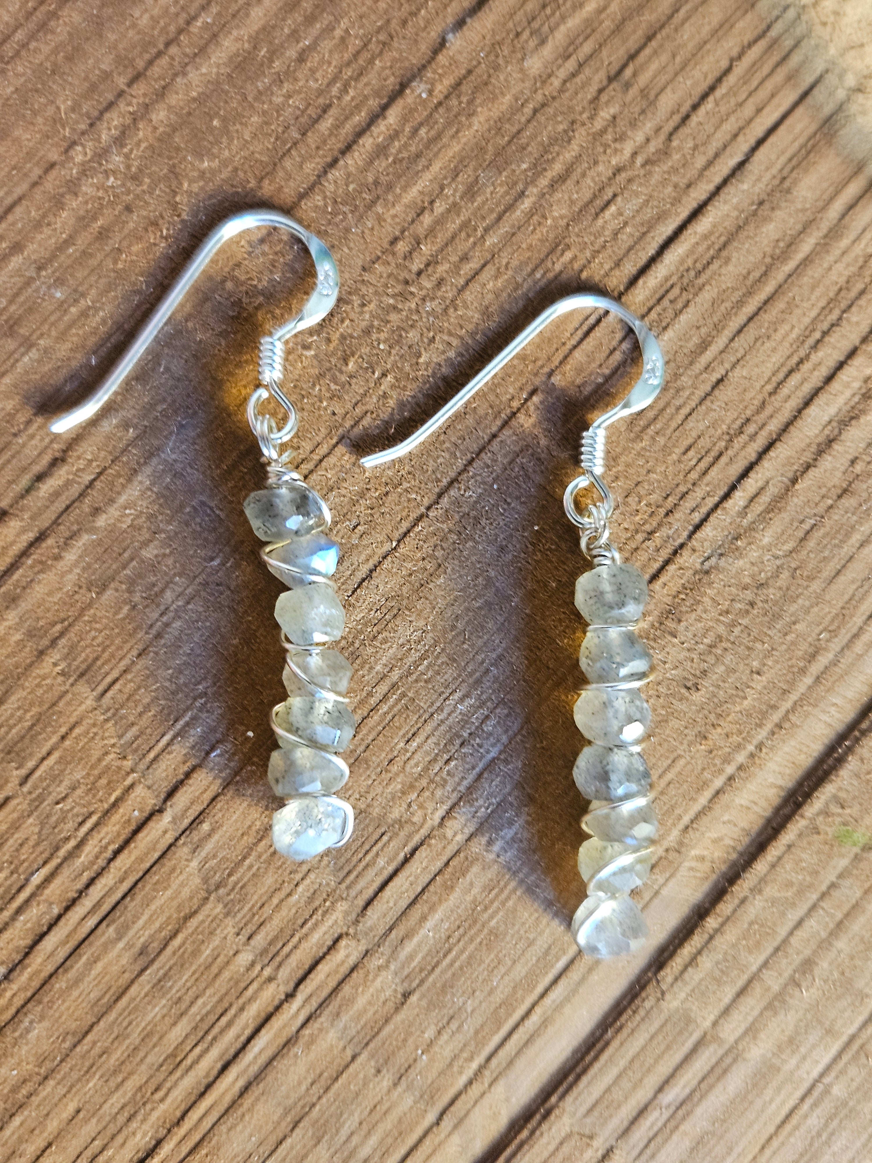 Pair of beaded earrings on a wooden surface