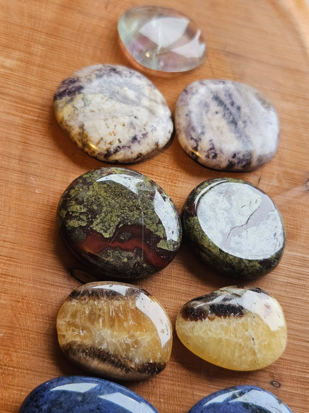 Collection of smoothstones on a wooden surface