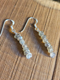 Pair of beaded earrings on a wooden surface