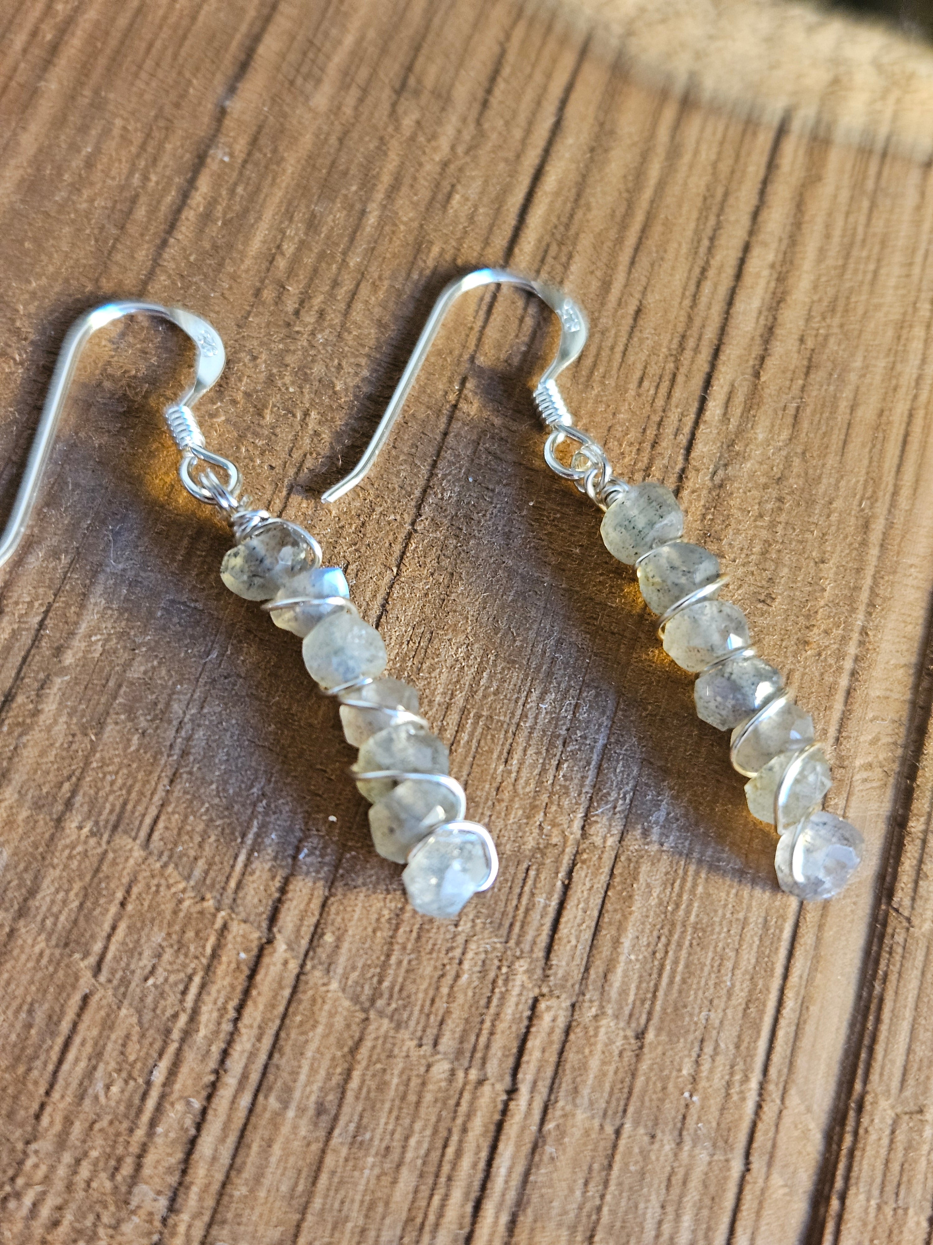 Pair of beaded earrings on a wooden surface