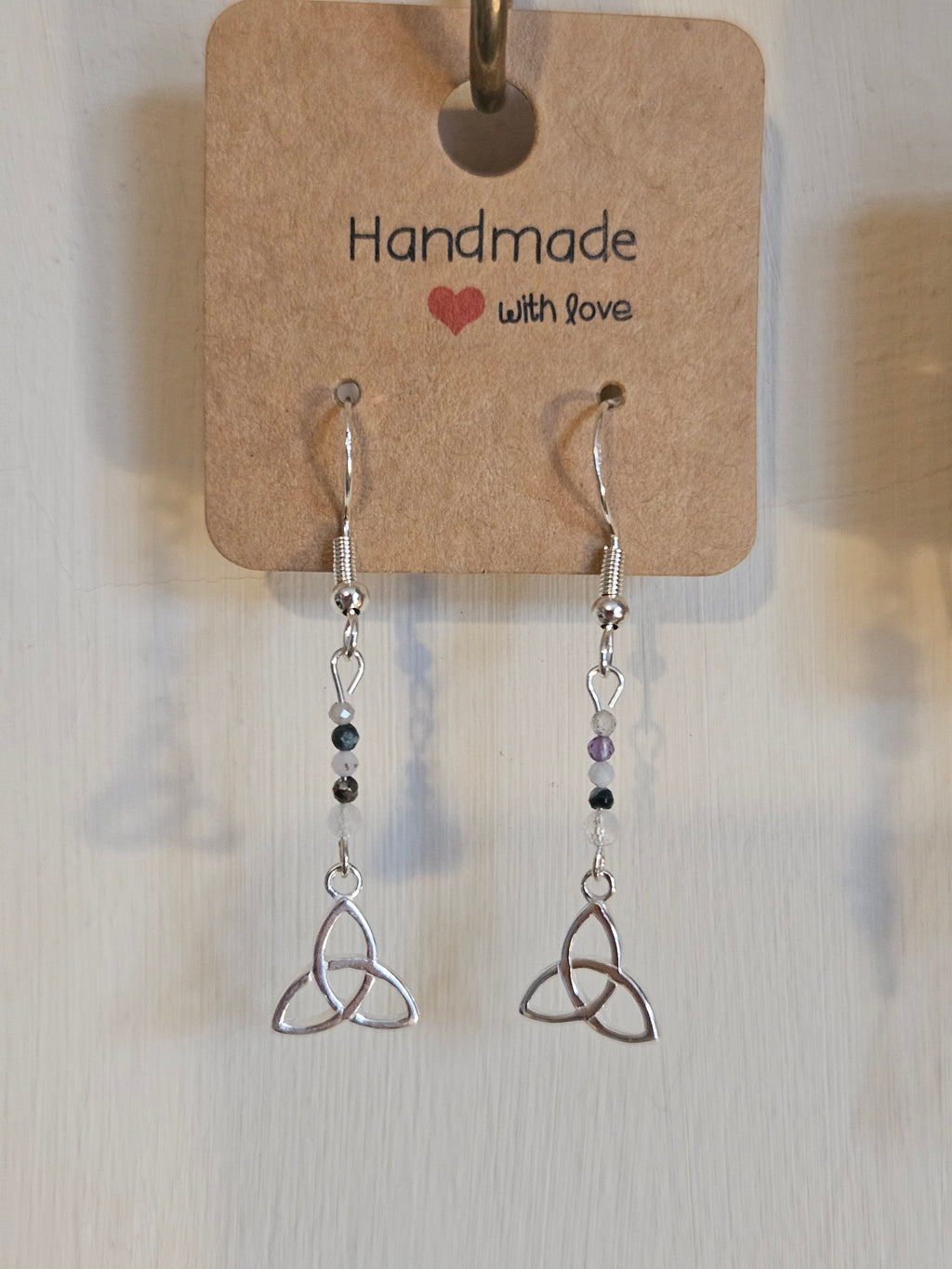Pair of silver earrings with beaded extensions on a 'Handmade with Love' card.