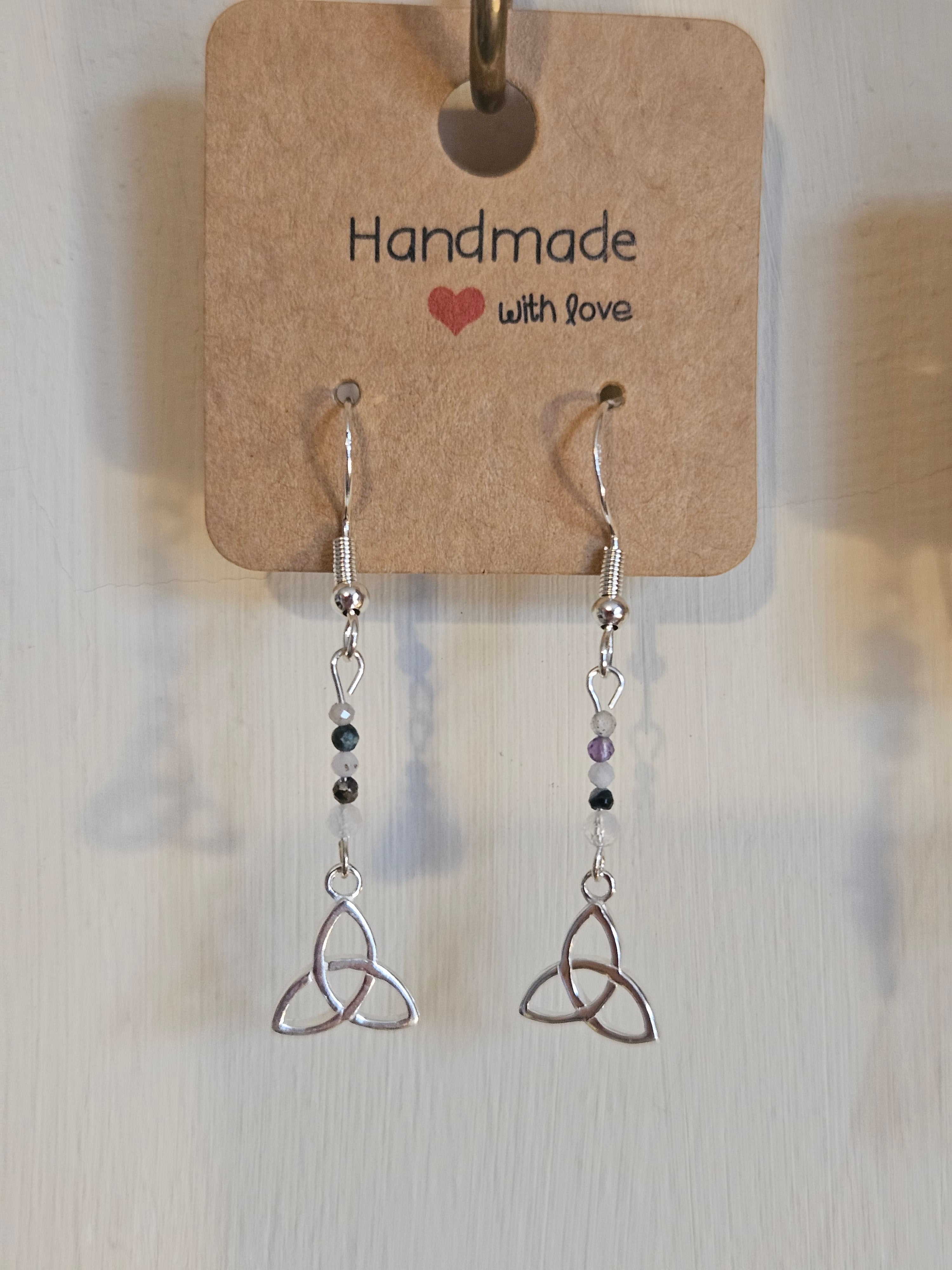 Pair of silver earrings with beaded extensions on a 'Handmade with Love' card.