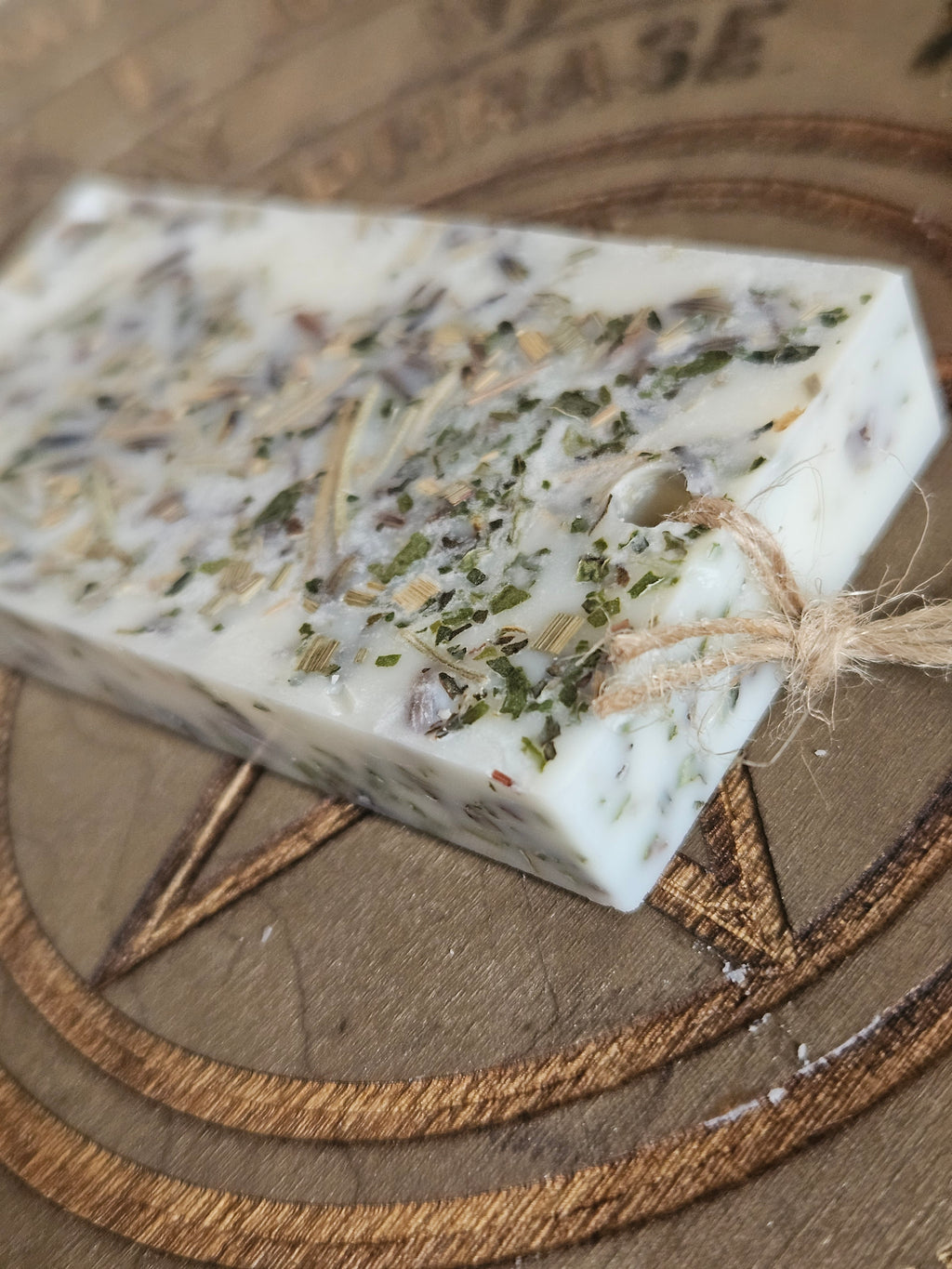Rectangular scented pendant with natural ingredients on a textured surface