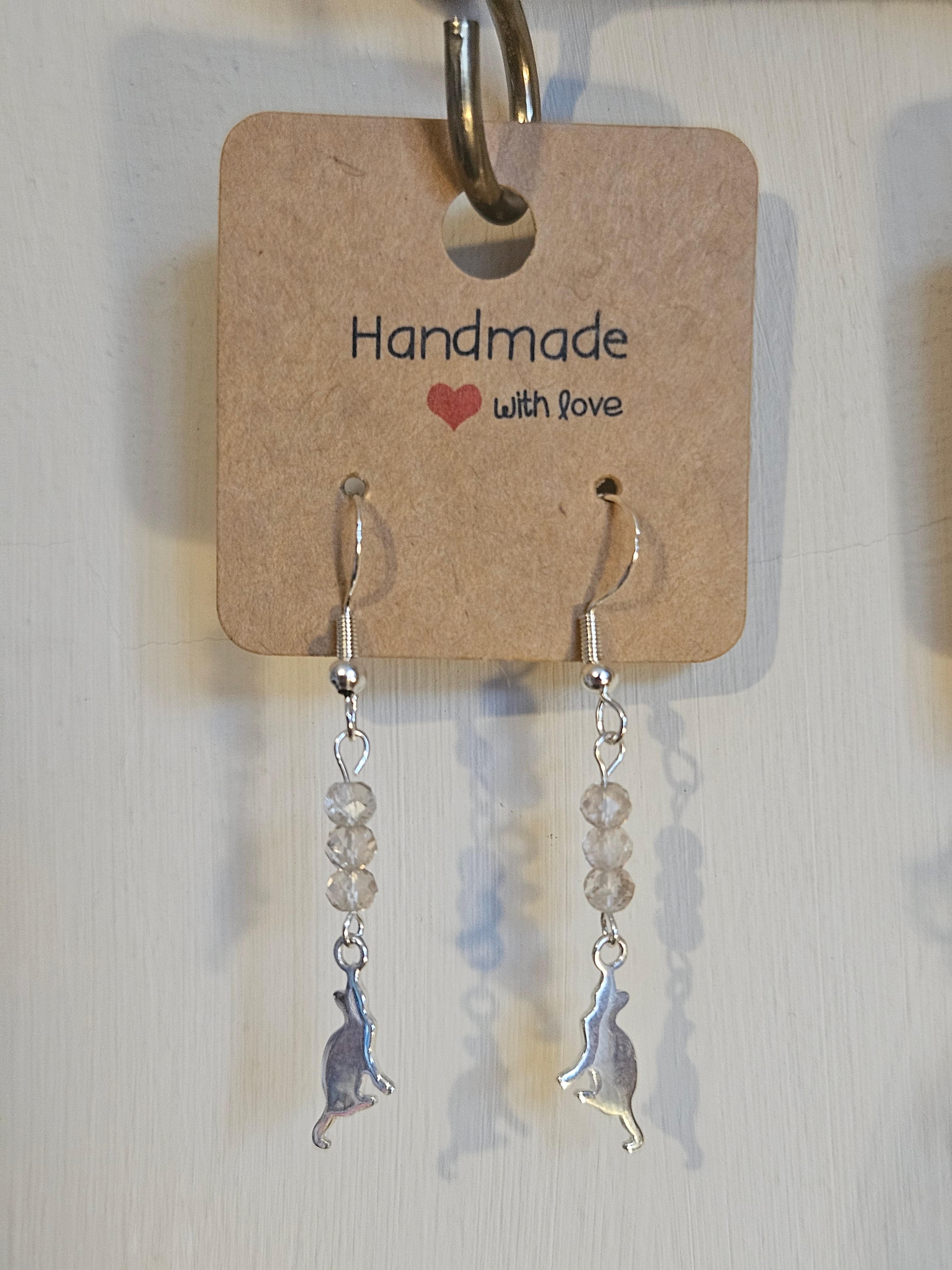 Silver earrings with beaded chain on a 'Handmade with Love' card.