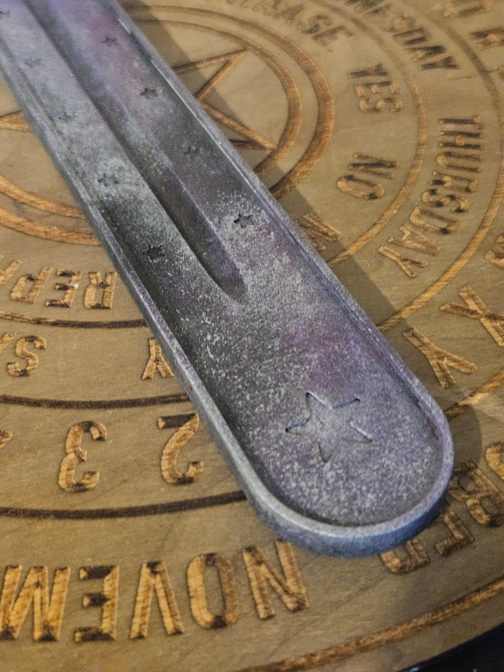 Close u of purple and silver ash catcher with stars