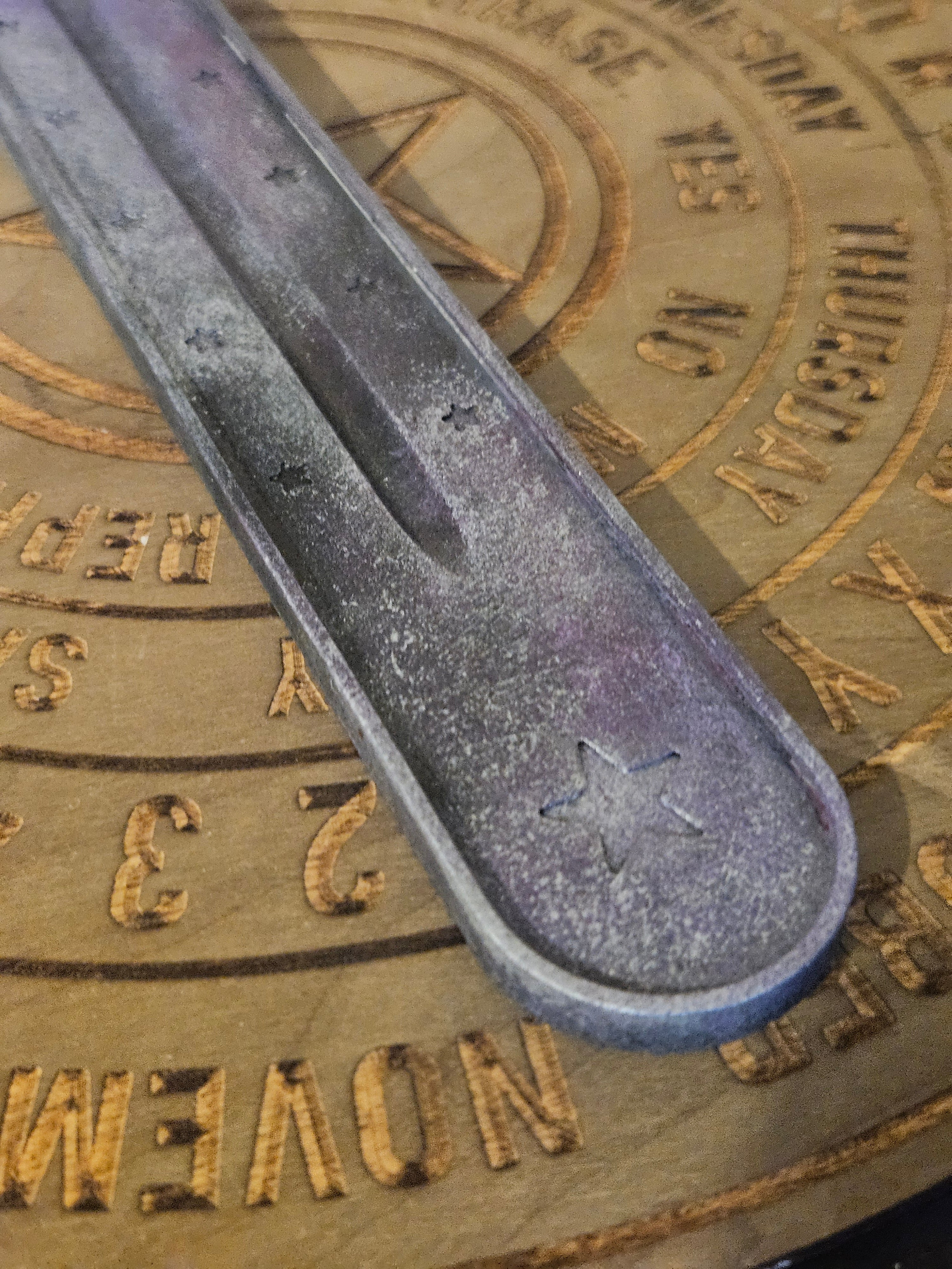 Close u of purple and silver ash catcher with stars