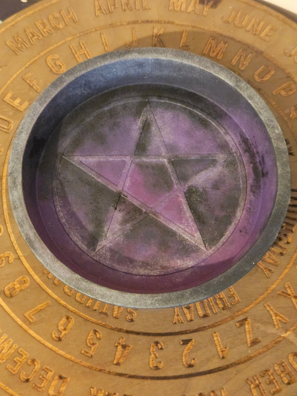 Close-up of a circular object with a star design and gold text around the edge.