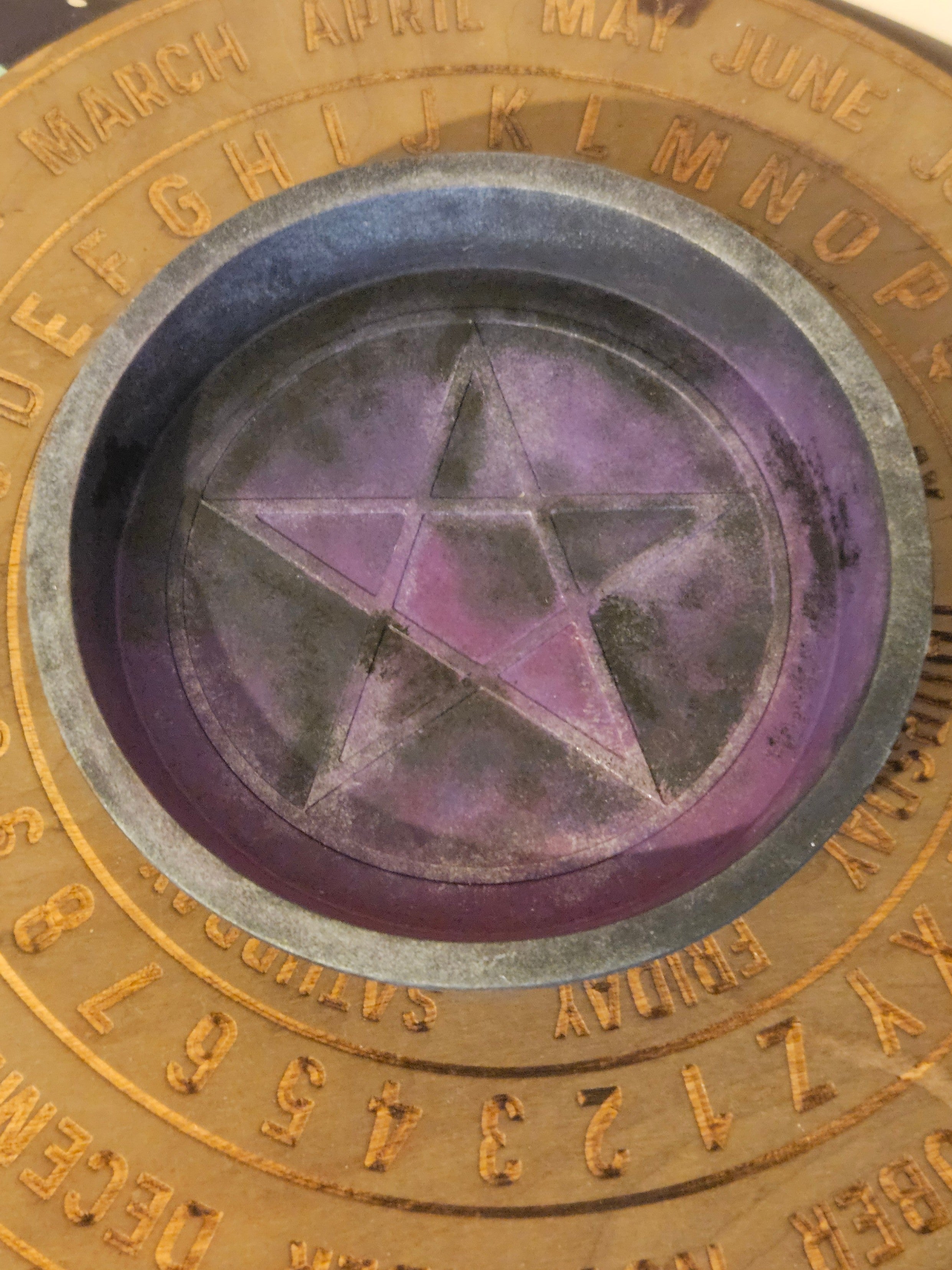 Close-up of a circular object with a star design and gold text around the edge.
