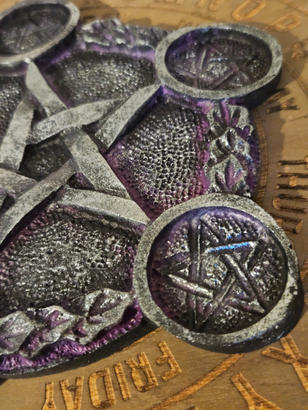 Close-up of decorative tea light holder with star and floral designs on a textured background.